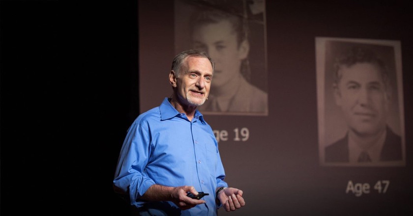 Robert Waldinger on the TED stage, beside two archive portraits labelled age 19 and age 47